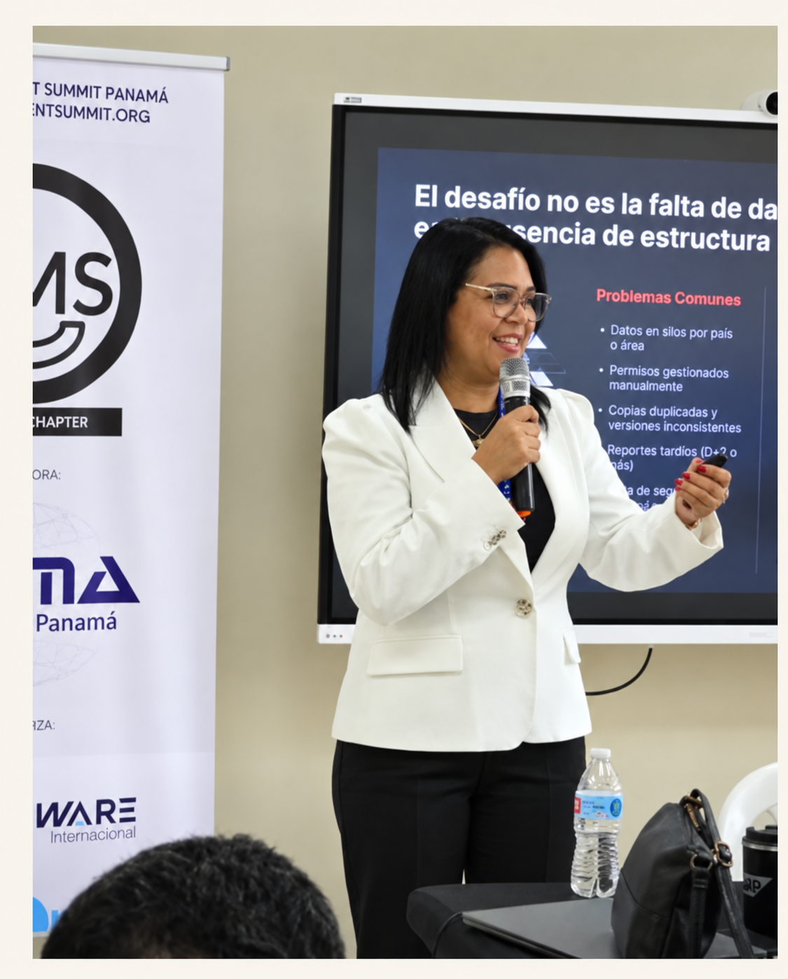 Keisa Ávila en su charla en DAMA Panamá, frente a una lámina sobre la falta de estructura en los datos